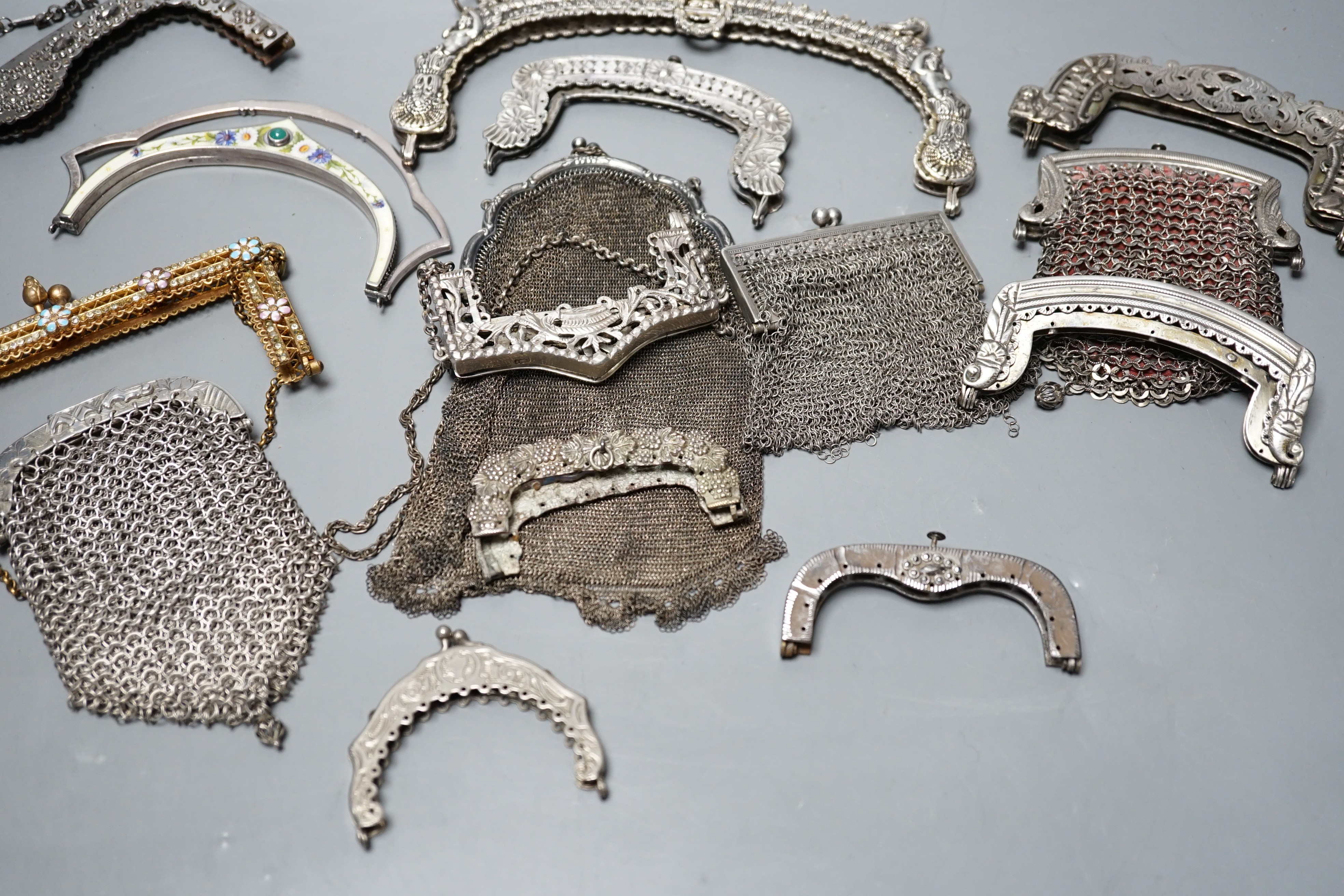 A silver enamel handbag frame, a gilt metal diamanté and enamel frame, eight mixed metal frames, a chain mail bag and three purses, late 19th early 20th century